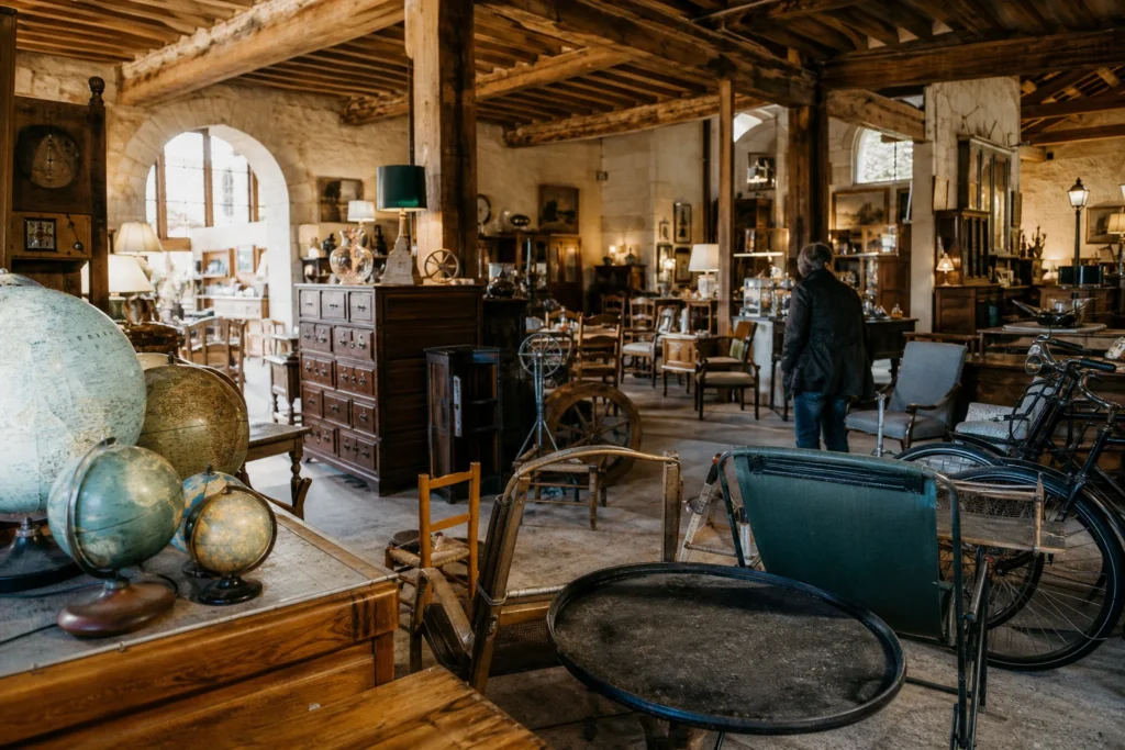 shoppers browsing antique and vintage market stalls at Les Brocs du Relais d’Avezé in France, Perche
