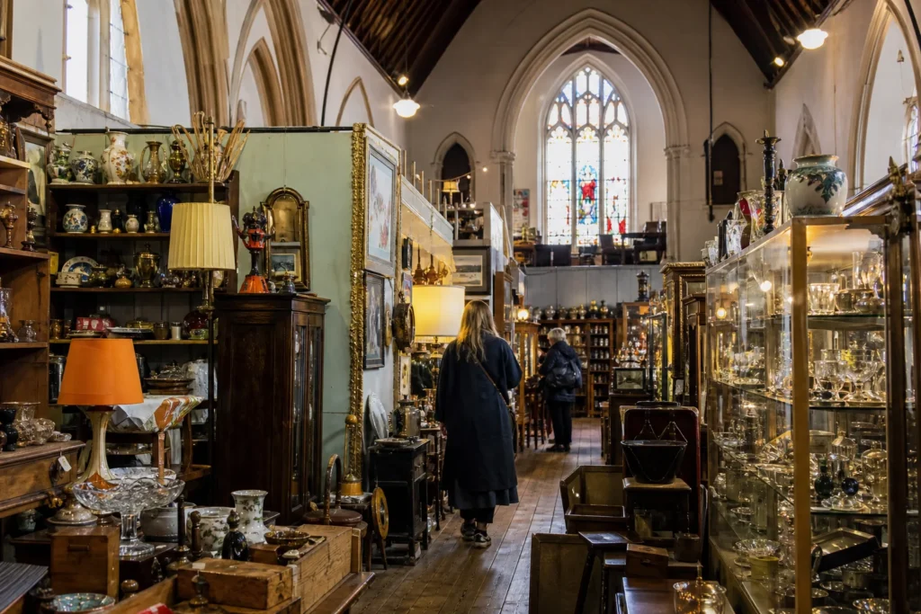 shoppers browsing antique and vintage market stalls at Lewes Flea Market in United Kingdom