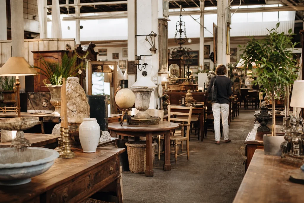 shoppers browsing antique and vintage market stalls at L’Ile aux Brocantes in Provence