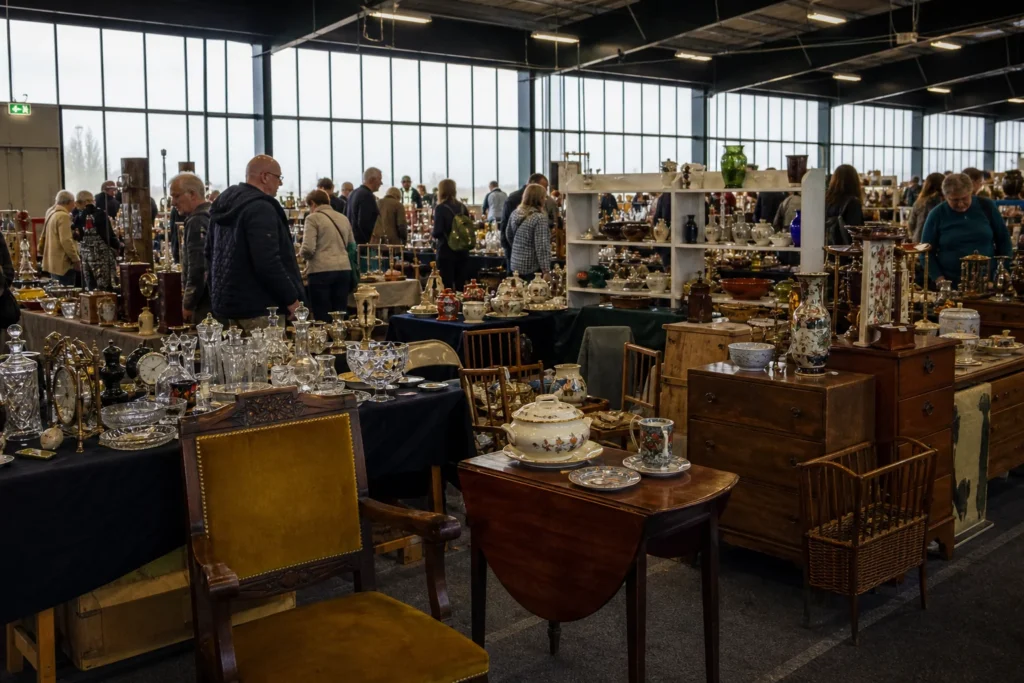 shoppers browsing antique and vintage market stalls at Lingfield Antiques Collectables and Vintage Fair in United Kingdom