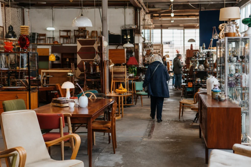 shoppers browsing antique and vintage market stalls at Loods 040 in Netherlands