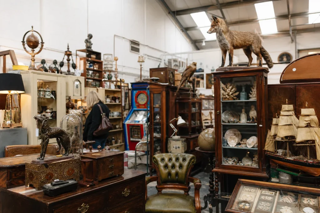 shoppers browsing antique and vintage market stalls at Lostwithiel Antique Centre in United Kingdom