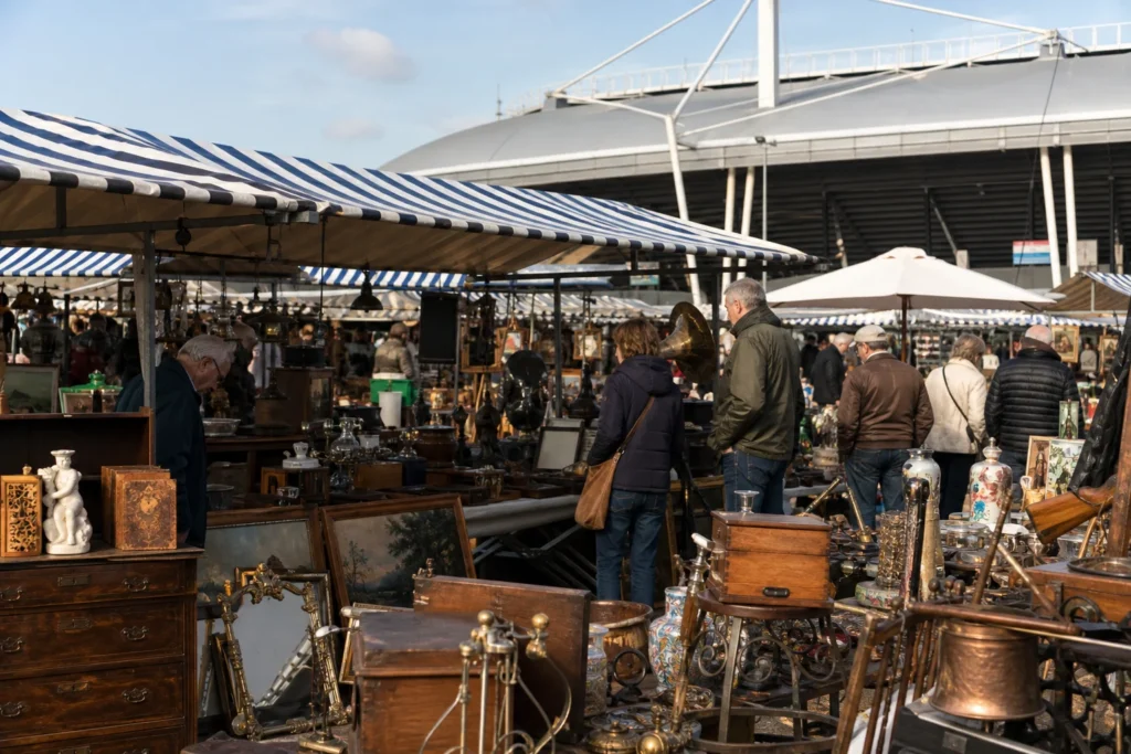 shoppers browsing antique and vintage market stalls at Luikse Markt Arnhem in Netherlands