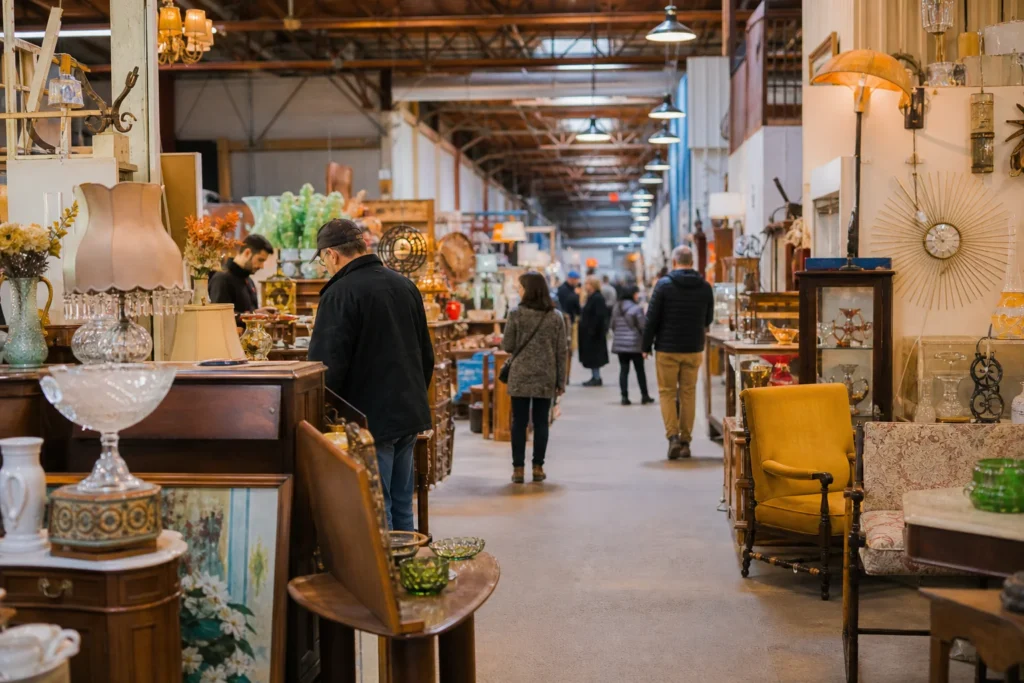 shoppers browsing antique and vintage market stalls at Marché aux Puces St-Michel in Canada, Montreal, Quebec