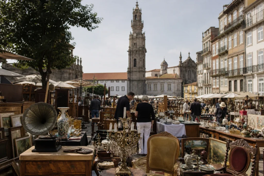 shoppers browsing antique and vintage market stalls at Mercadinho dos Clérigos in Portugal