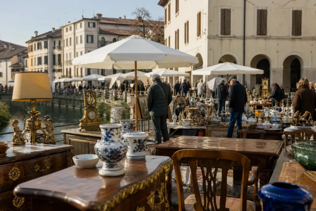 shoppers browsing antique and vintage market stalls at Mercatino dell’Antiquariato a Sacile in Italy