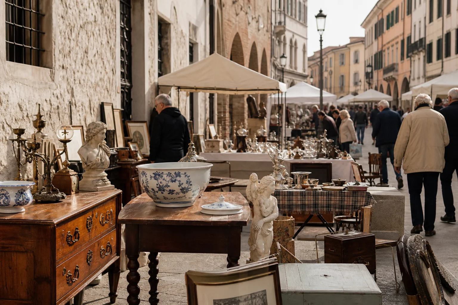shoppers browsing antique and vintage market stalls at Mercatino dell’Antiquariato a Treviso Cose d’Altri Tempi in Italy