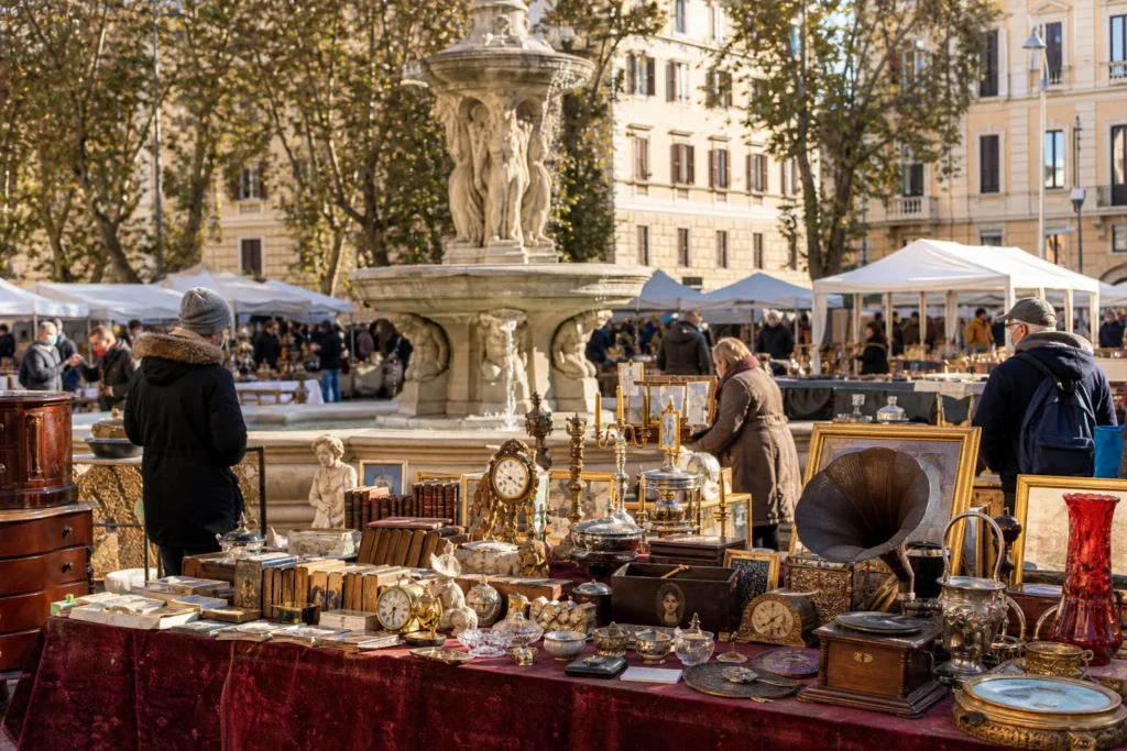 shoppers browsing antique and vintage market stalls at Mercatino dell’Antiquariato di Piazza dei Quiriti in Italy, Rome