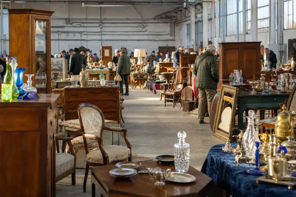 shoppers browsing antique and vintage market stalls at Mercato antiquario di Pistoia in Italy