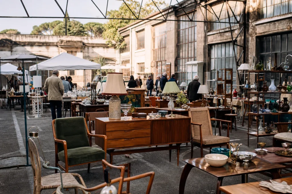 shoppers browsing antique and vintage market stalls at Mercato Borghetto Flaminio in Italy, Rome