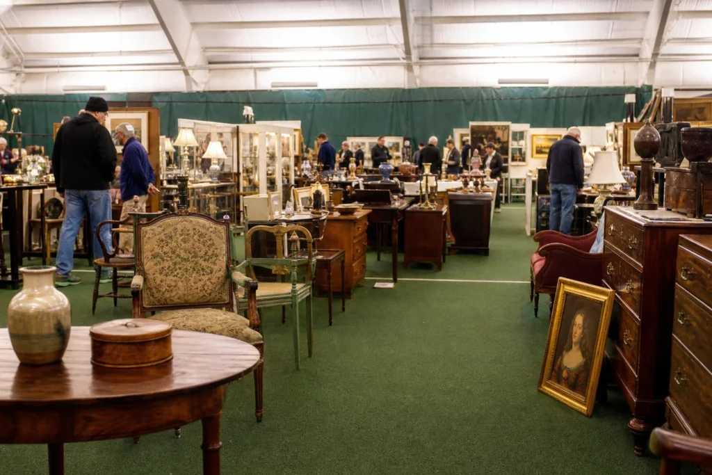 shoppers browsing antique and vintage market stalls at Milford Antiques Show in New Hampshire