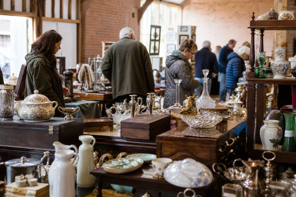 shoppers browsing antique and vintage market stalls at Mobberley Antique and Collector’s Fair in United Kingdom