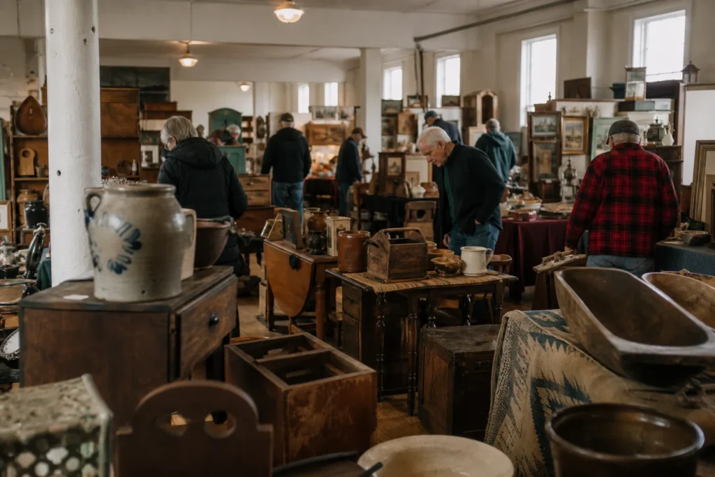 shoppers browsing antique and vintage market stalls at Montpelier Antiques Market in Vermont