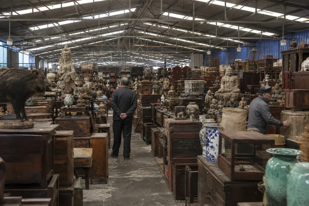 shoppers browsing antique and vintage market stalls at Mu Lan Hua Ge Jia Ju Li Curio Company in China