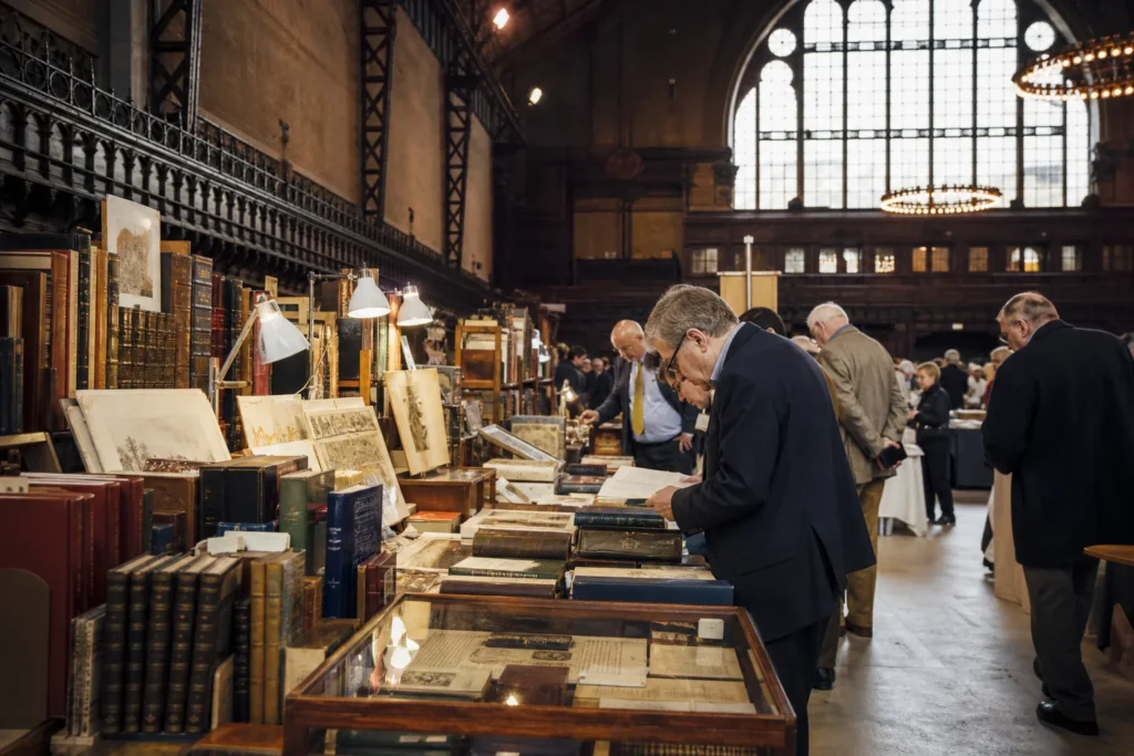 shoppers browsing antique and vintage market stalls at New York Antiquarian Book Fair in New York State