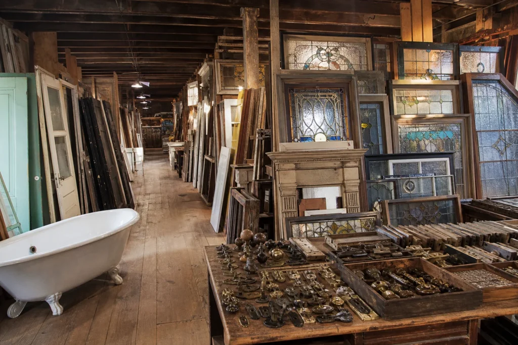 shoppers browsing antique and vintage market stalls at Old House Parts Company in Maine