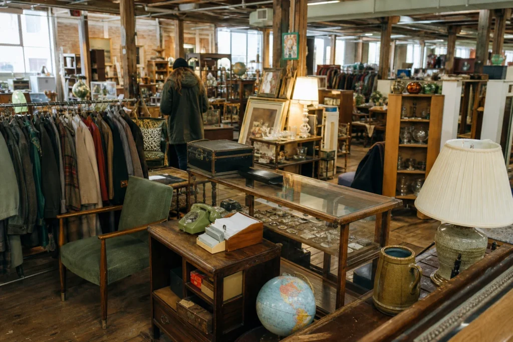 shoppers browsing antique and vintage market stalls at Portland Flea-For-All in Maine