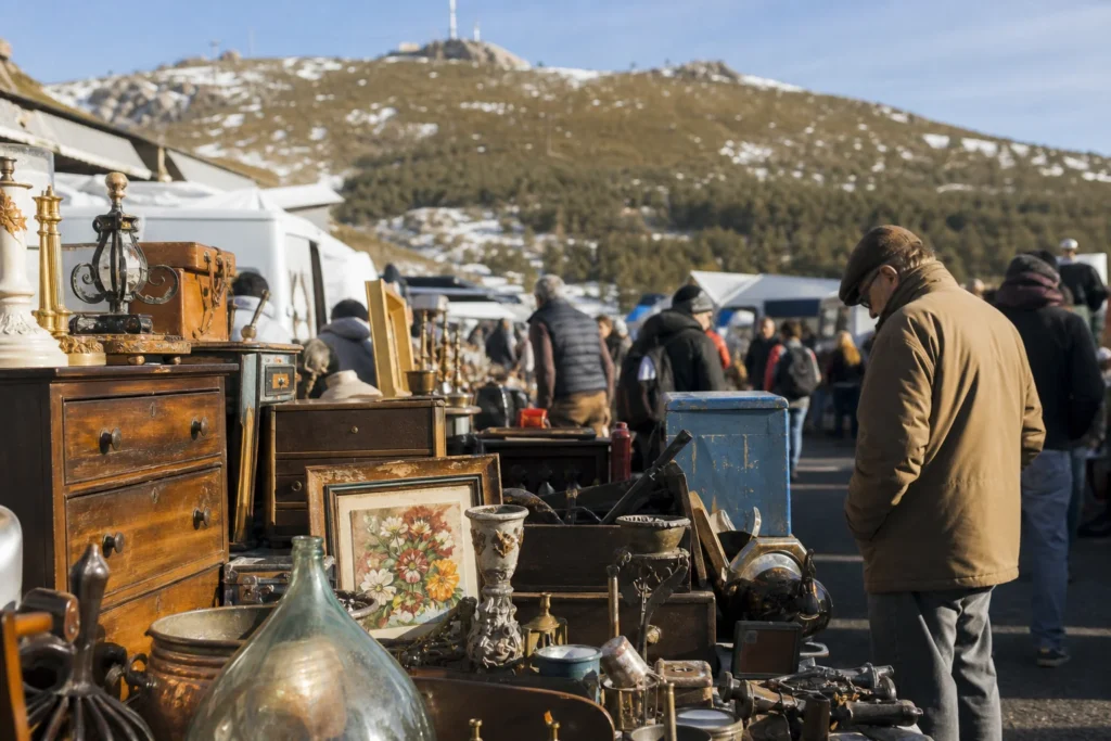 shoppers browsing antique and vintage market stalls at Rastro de Navacerrada in Spain