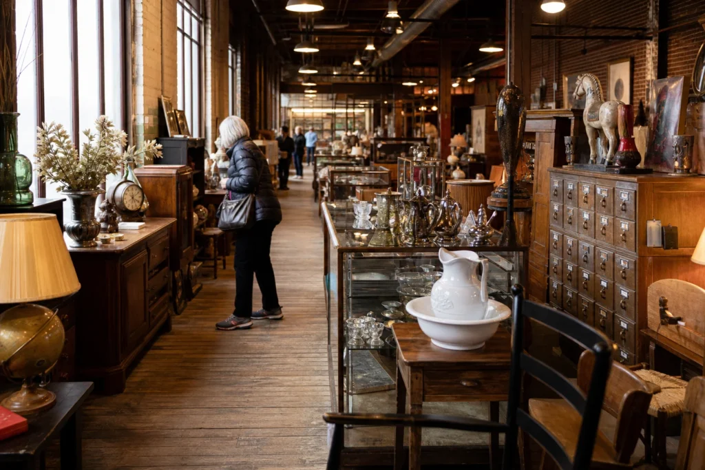 shoppers browsing antique and vintage market stalls at River Market Antiques in Kansas City, Missouri