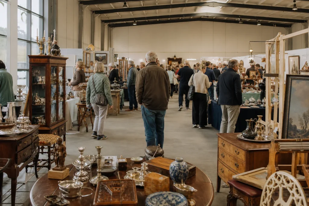 shoppers browsing antique and vintage market stalls at Rødekro Arts & Antiques Fair in Copenhagen