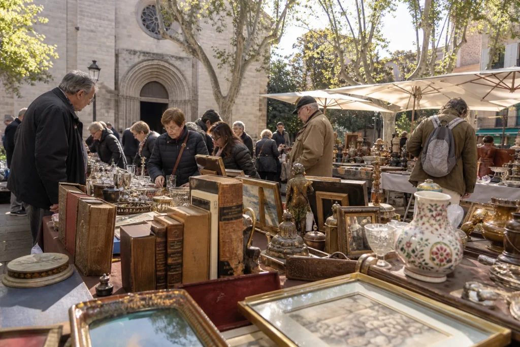 shoppers browsing antique and vintage market stalls at Sarrià Antiques Fair in Spain