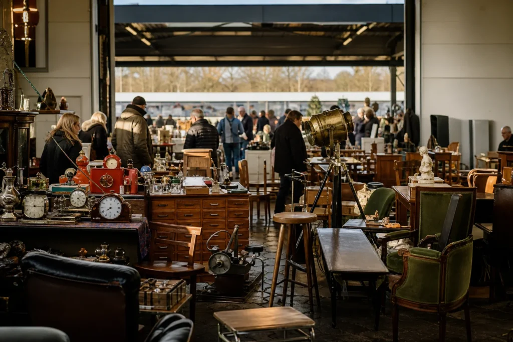 shoppers browsing antique and vintage market stalls at Snuffelland in Belgium