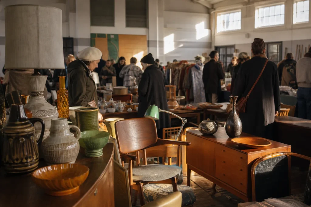 shoppers browsing antique and vintage market stalls at So Last Century Vintage and Retro Fair in London