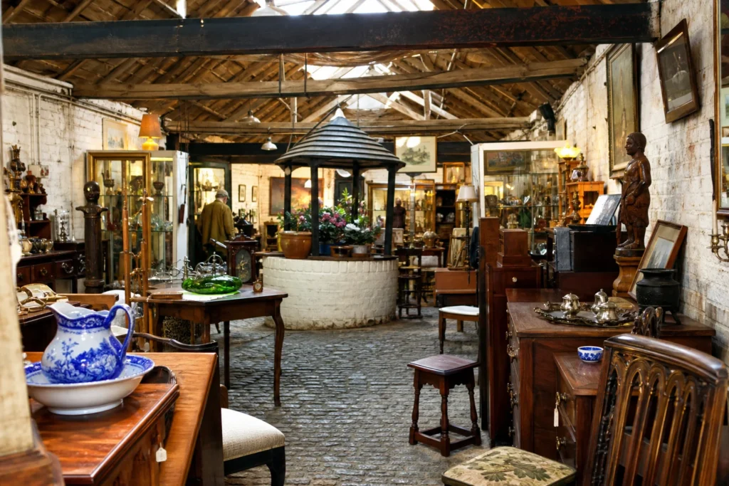 shoppers browsing antique and vintage market stalls at Stable Antiques in United Kingdom