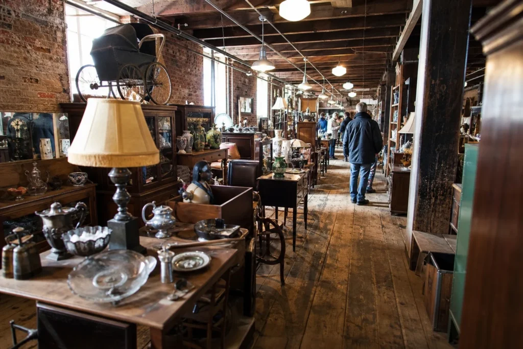 shoppers browsing antique and vintage market stalls at Strasburg Antique Market in Pennsylvania