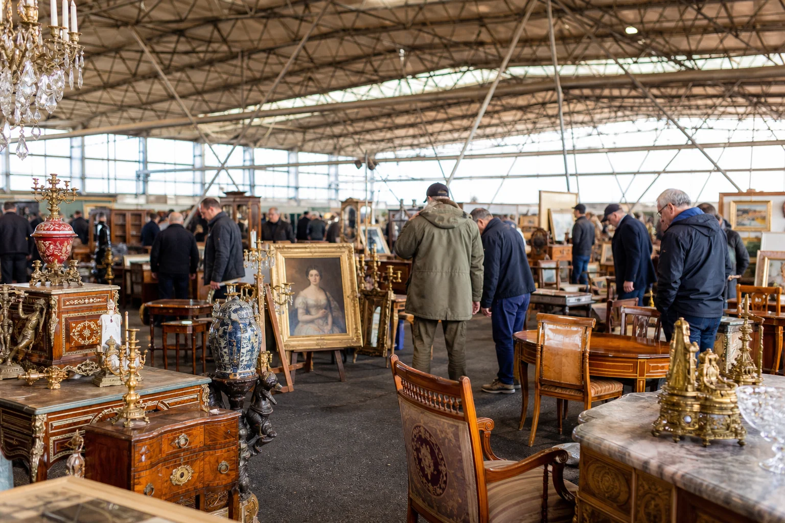 shoppers browsing antique and vintage market stalls at Sunbury Antiques Market at Kempton Park in United Kingdom