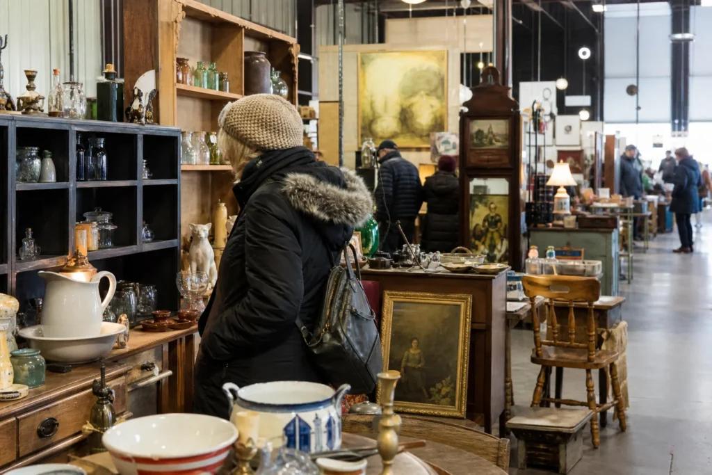 shoppers browsing antique and vintage market stalls at Tables To Teacups Indoor Flea Market in Colorado