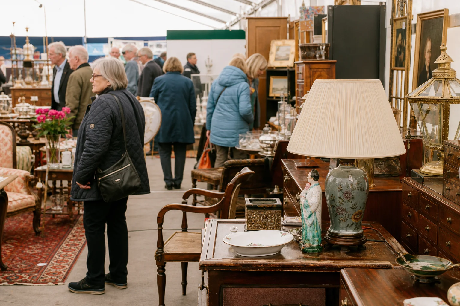 shoppers browsing antique and vintage market stalls at The Northern Antiques Fair in United Kingdom