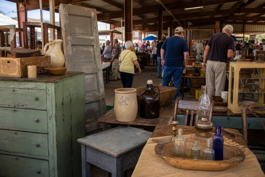 shoppers browsing antique and vintage market stalls at Tri-State Antique Market in Indiana