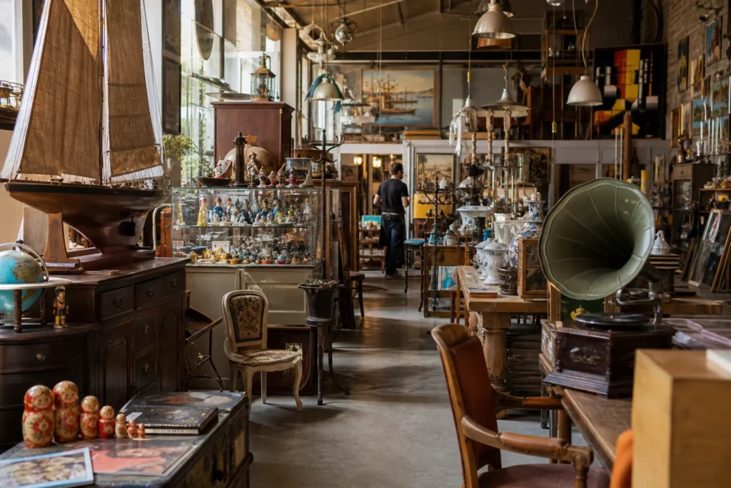 shoppers browsing antique and vintage market stalls at Troc en Stock Antibes in France, Provence