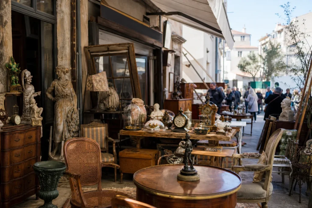 shoppers browsing antique and vintage market stalls at Village des Puces de Fifiturin in France, Provence