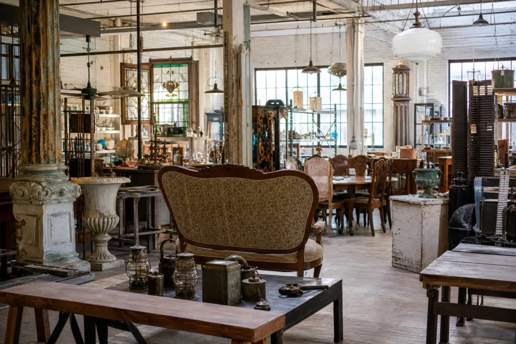 shoppers browsing antique and vintage market stalls at West End Architectural Salvage in Iowa