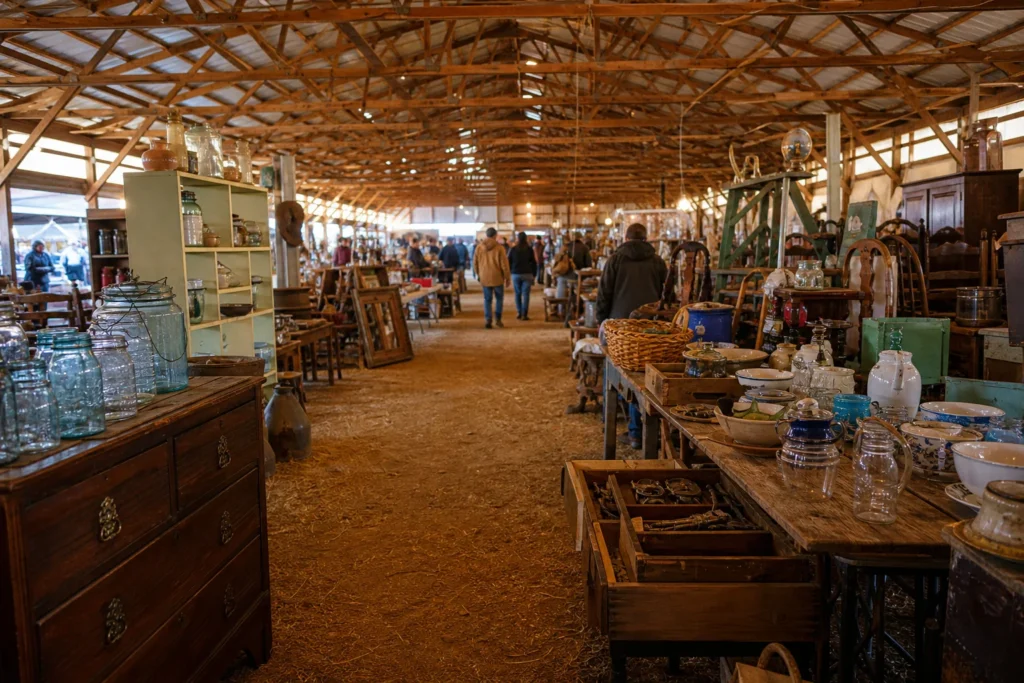 shoppers browsing antique and vintage market stalls at What Cheer Flea Market in Iowa