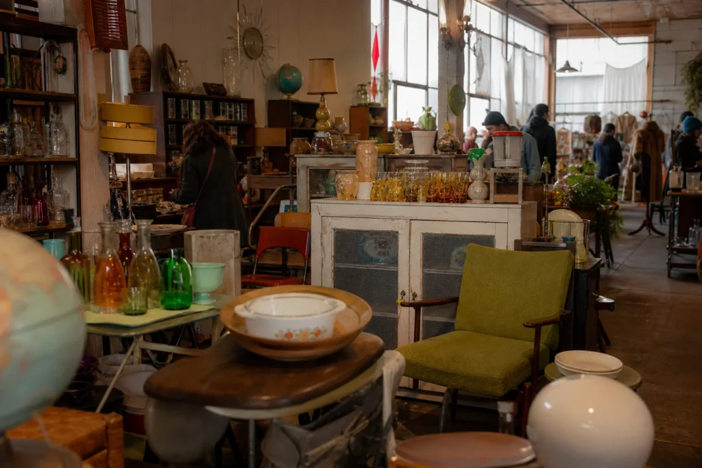 shoppers browsing antique and vintage market stalls at 21st Century Flea Market in British Columbia, Canada, Vancouver