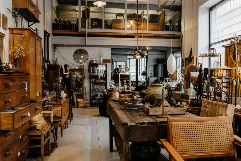 shoppers browsing antique and vintage market stalls at Kaivarin Kanuuna in Finland