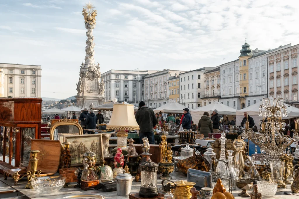 shoppers browsing antique and vintage market stalls at Linzer Kuriositäten-Flohmarkt in Austria