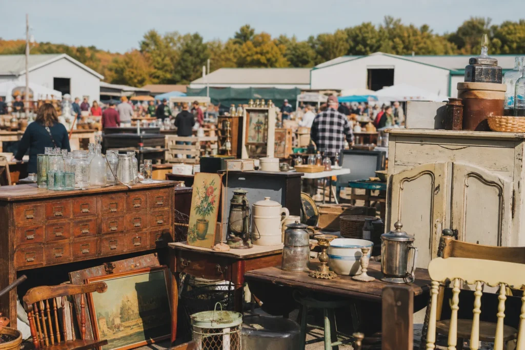 shoppers browsing antique and vintage market stalls at Marché aux Puces Lachute in Canada, Quebec