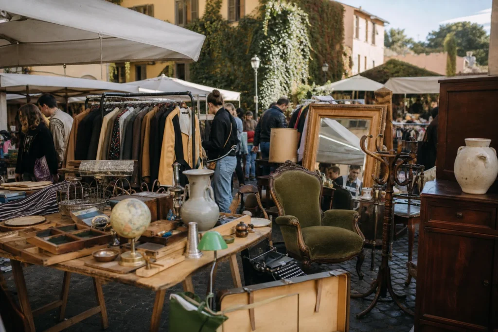 shoppers browsing antique and vintage market stalls at MercatoMonti Urban Market in Italy, Rome