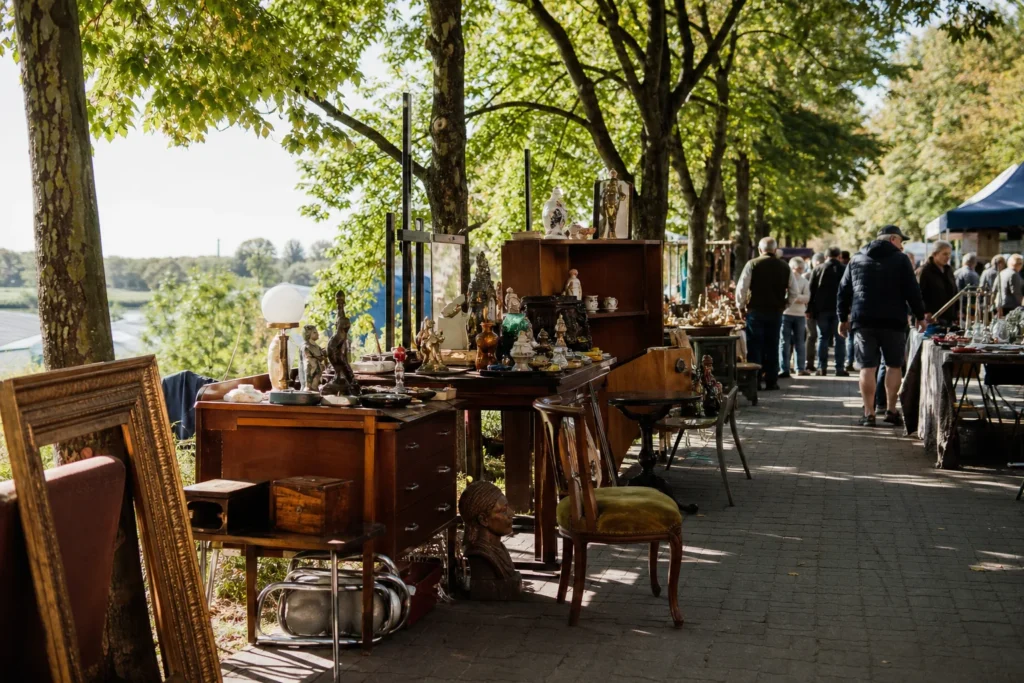 shoppers browsing antique and vintage market stalls at ZOO Market in Poland